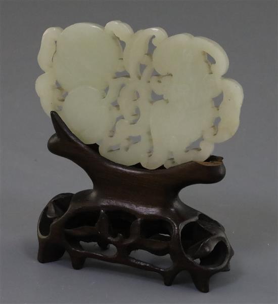A Chinese pale celadon jade plaque, 19th century, 8.4cm, wood stand